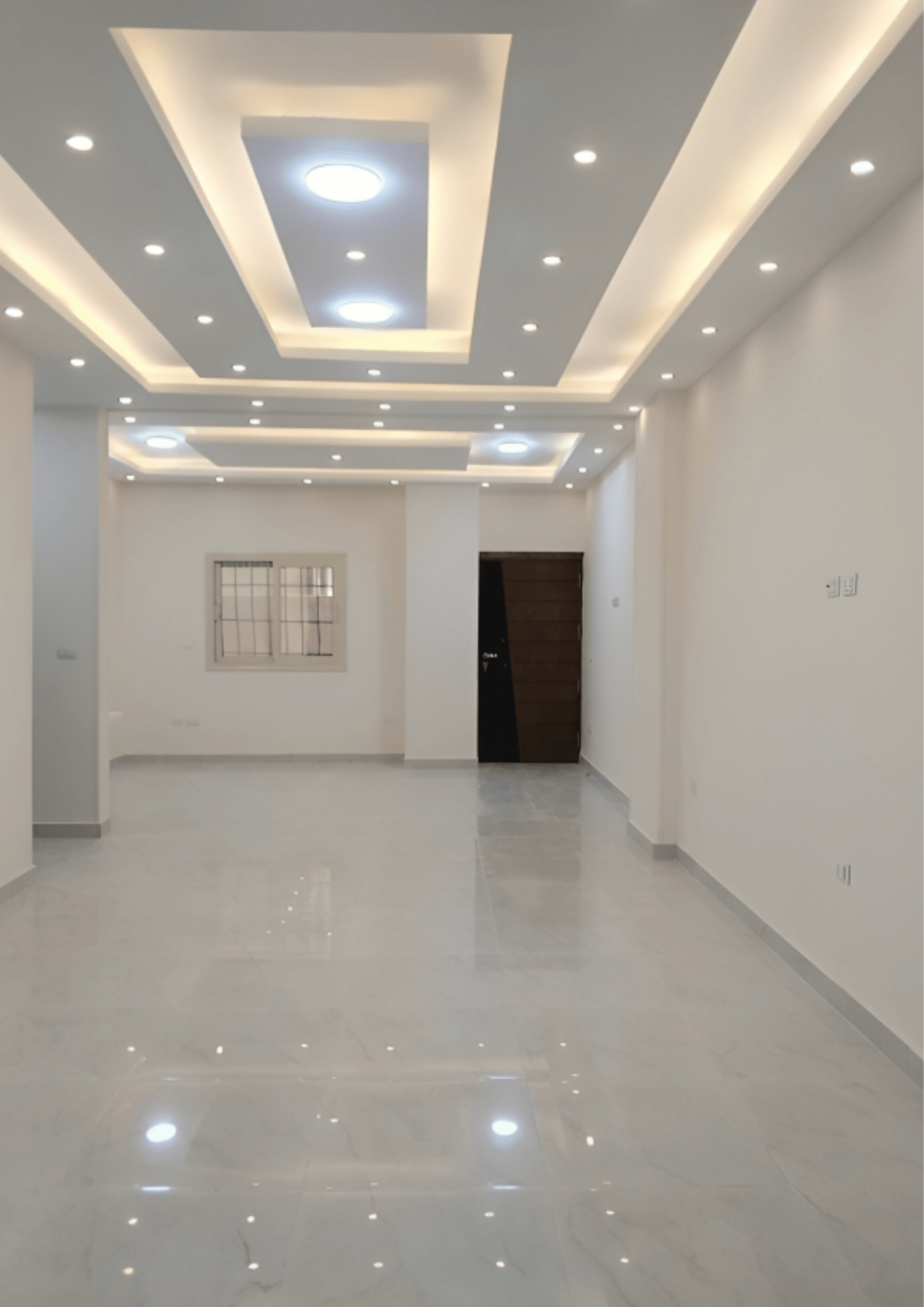 Minimalist living room with leather sofa, abstract art, and wooden wall panels