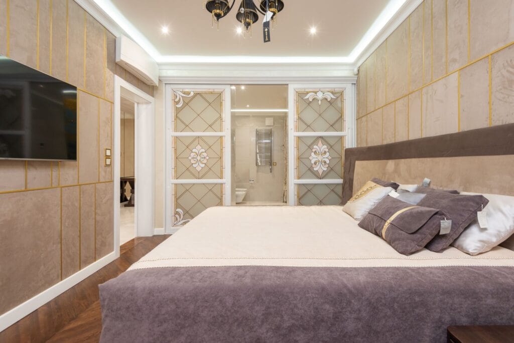 Luxury bedroom with a cove-lit false ceiling and premium finishes