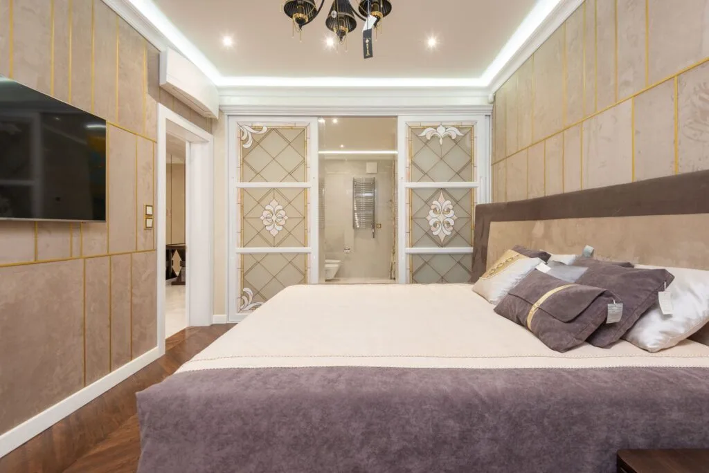 Luxury bedroom with a cove-lit false ceiling and premium finishes