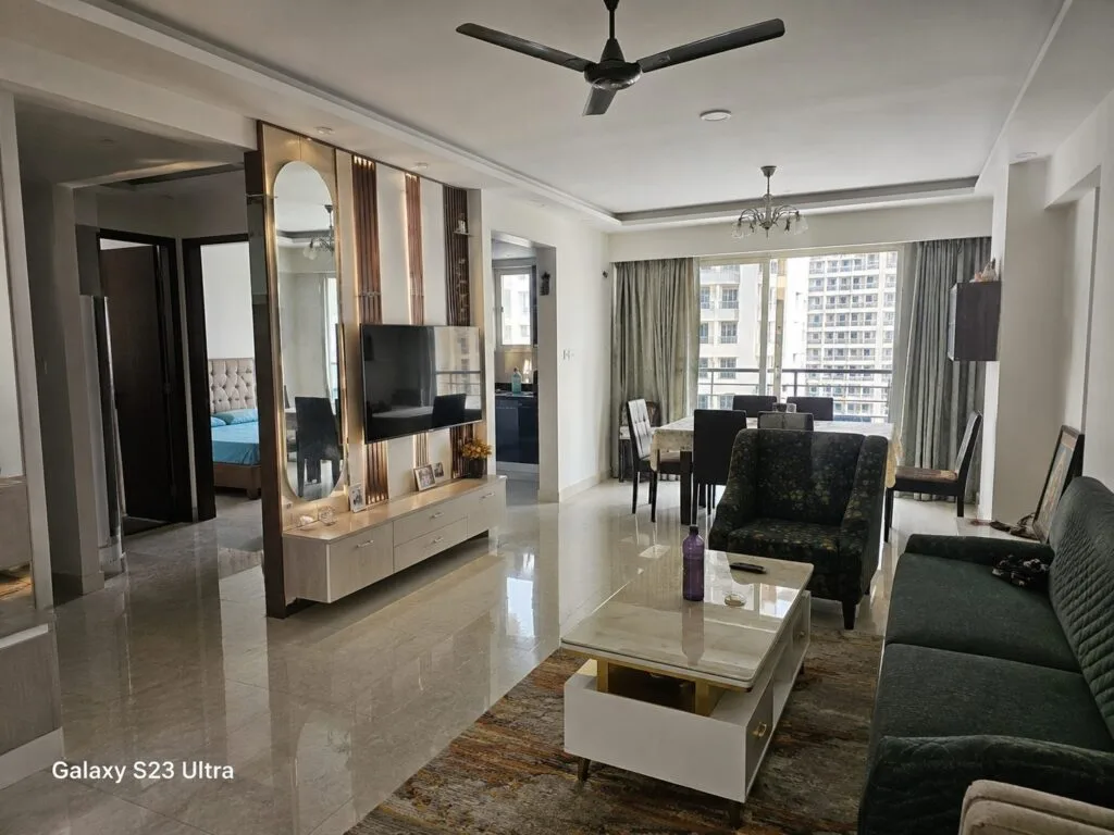 Completed living room interior by Aarna Constructions in Greater Noida