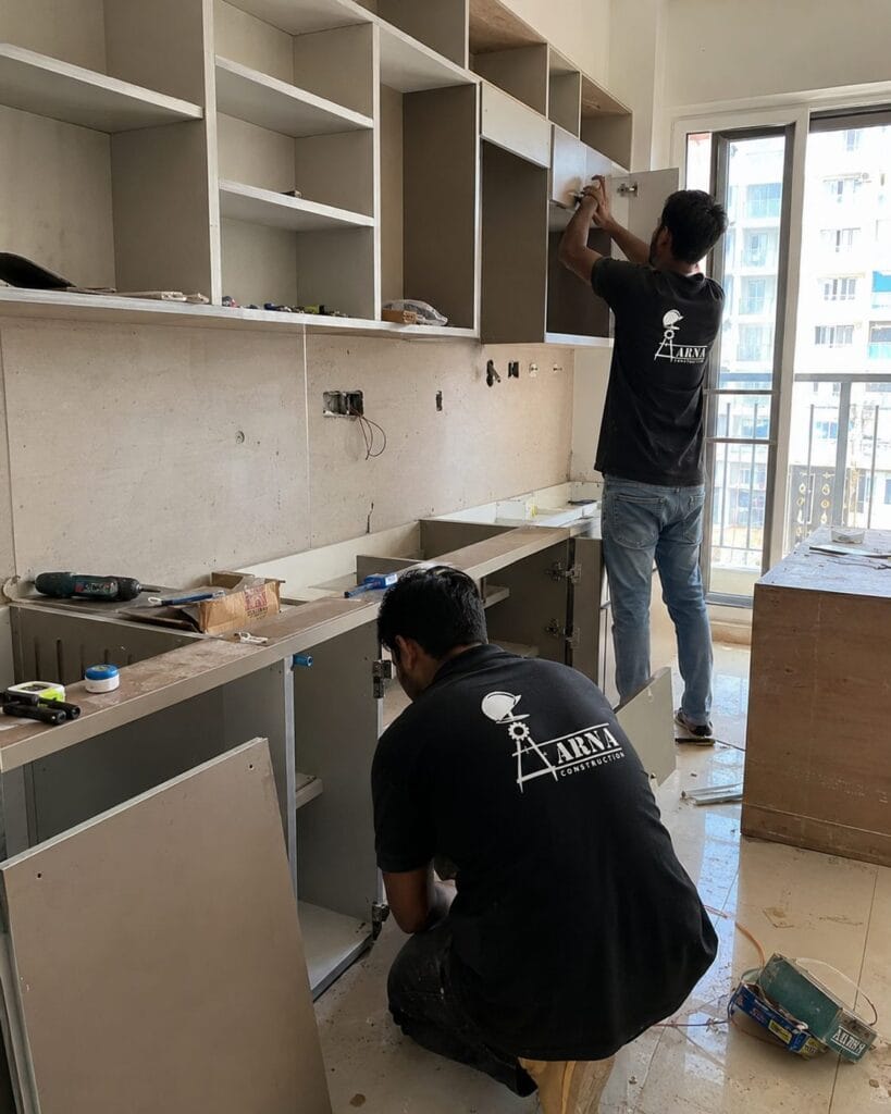 Modular kitchen cabinet installation by Aarna Constructions in Greater Noida