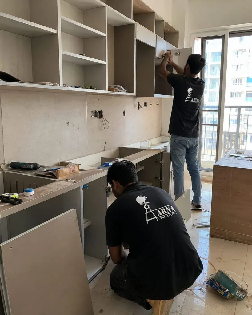 Modular kitchen cabinet installation by Aarna Constructions in Greater Noida