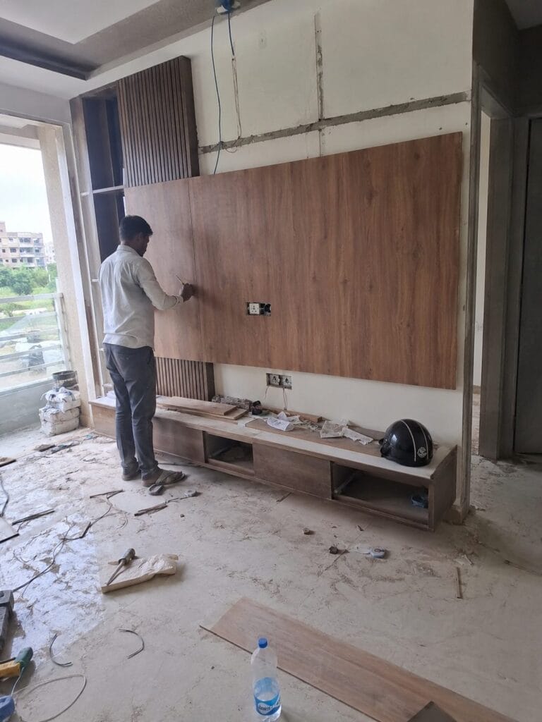 Wardrobe installation in a flat by Aarna Constructions in Greater Noida