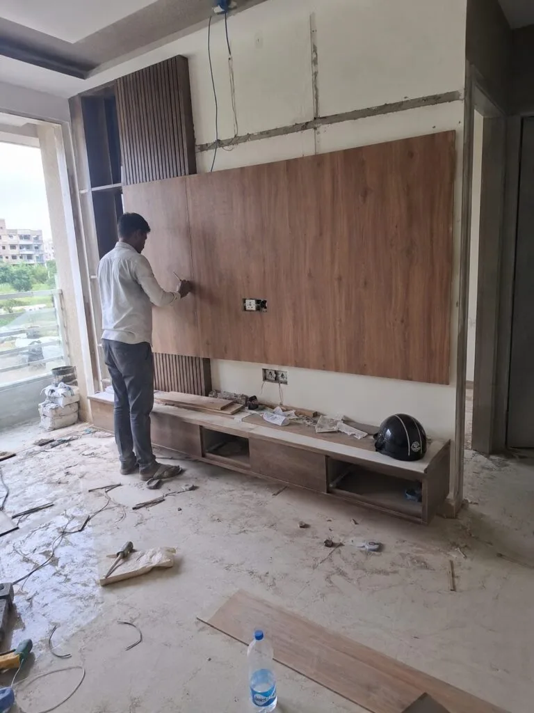 Wardrobe installation in a flat by Aarna Constructions in Greater Noida