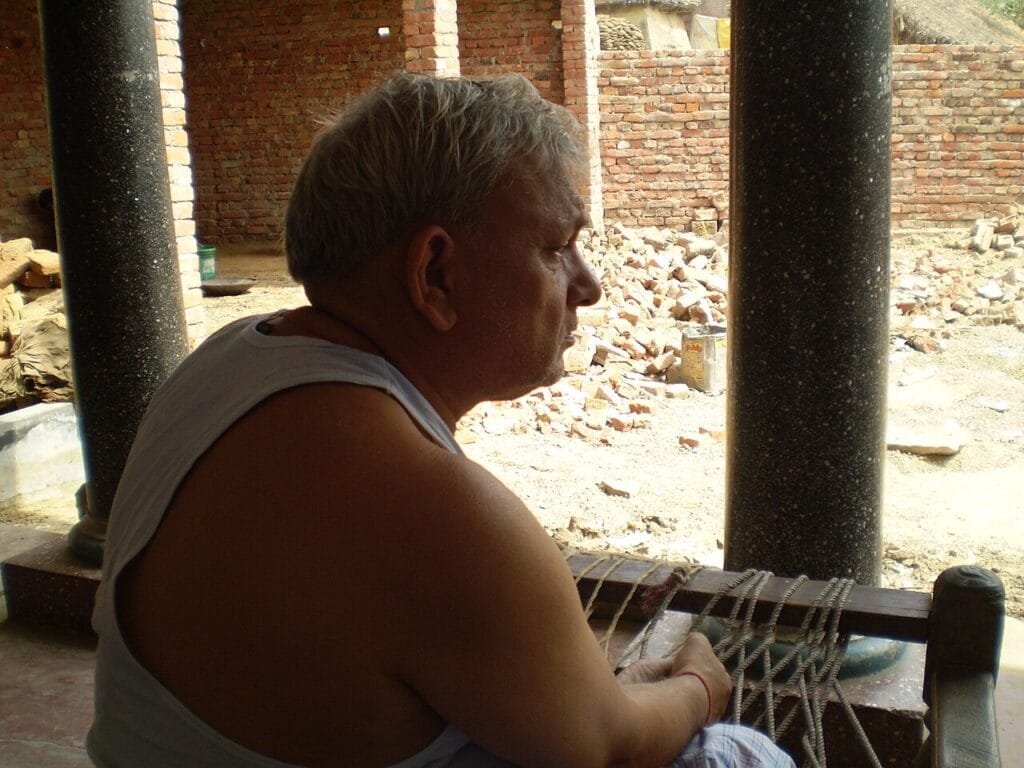 House owner watching construction work on his house in India, checking progress before releasing the next payment
