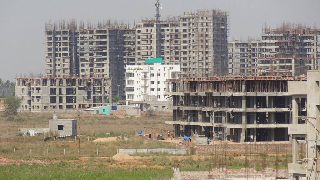 RCC frame buildings under construction showing columns and slabs, the stage that sets the pace of a house construction timeline