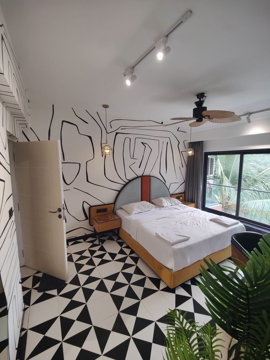 Bedroom interior in Greater Noida built around a hand-drawn black line-art feature wall